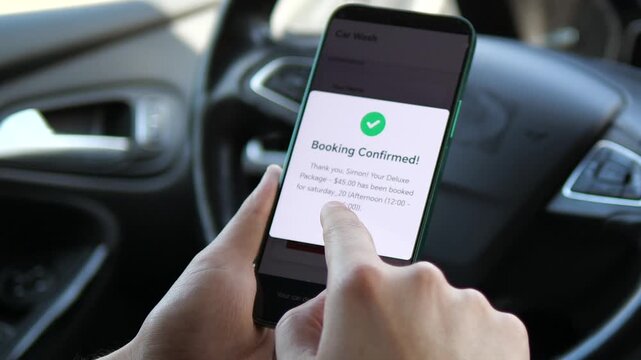 A person verifies their upcoming car care appointment through a mobile notification. This scene exemplifies how digital tools help manage personal tasks and schedules efficiently, suitable for