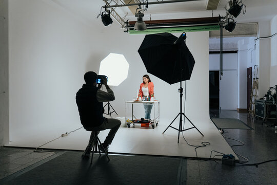 Photographer capturing a model in studio environment