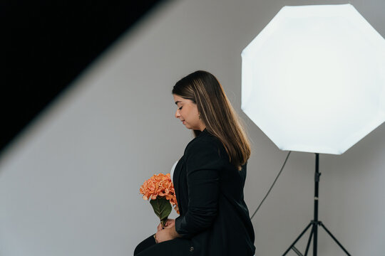 Studio portrait with flowers and soft lighting setup