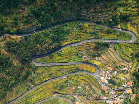 Winding road through lush Madeira landscape from above