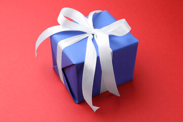 Beautiful gift box on red background, closeup © New Africa