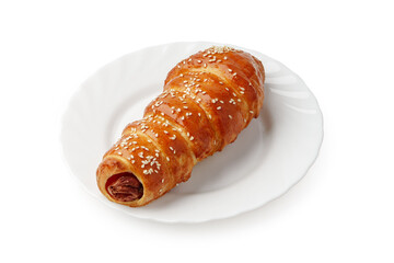 Freshly baked pastry with sesame seeds on a white plate