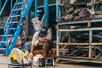 Female Welder Cutting Metal with Torch in Industrial Workshop