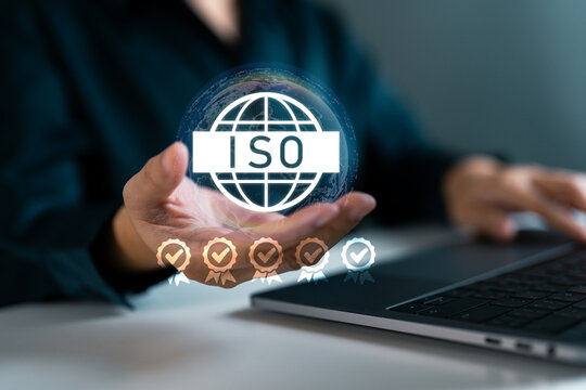 Businessperson holding digital ISO certification and quality assurance. Concept of quality management, global business standardization, and compliance excellence.