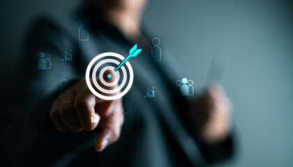 Businesswoman hand touching digital target icon with arrow, concept of goal achievement, precision marketing, customer targeting, business data strategy and strategic planning.