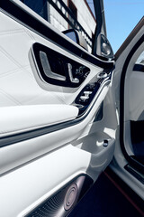 Detail view of luxury car interior showcasing sleek door panel design and modern features