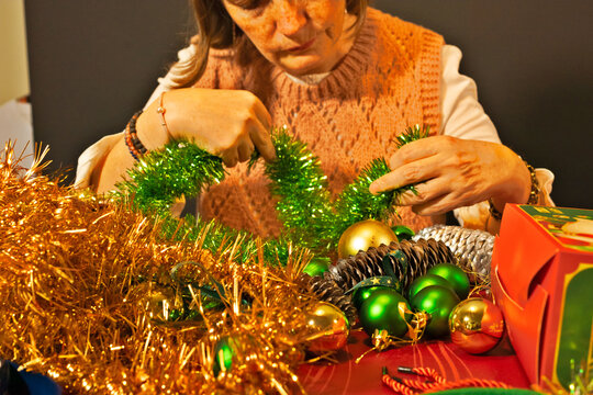 Woman decorating with Christmas tinsel and ornaments