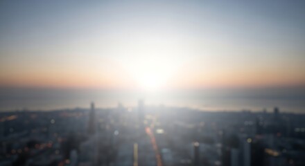 Golden sunrise over a blurry cityscape with tall buildings