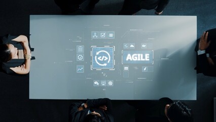 A group of professionals engages in a business meeting, exploring agile methodology through a dynamic digital interface projected on a modern conference table. Raster