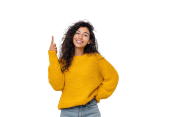 A smiling young woman in a yellow sweater raises one finger while posing against a transparent background.