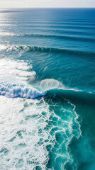 Obraz premium Aerial view of powerful ocean waves crashing with white foam and turquoise water