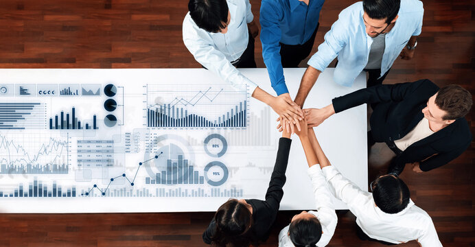 A dynamic team of professionals collaborates over market data and statistics, showcasing teamwork and strategic planning in a modern office environment. Scalp - Powered by Adobe