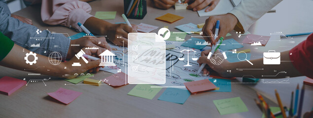 Engaging collaborative brainstorming session featuring diverse hands on a table filled with colorful sticky notes and digital icons, symbolizing creativity and teamwork. Trope