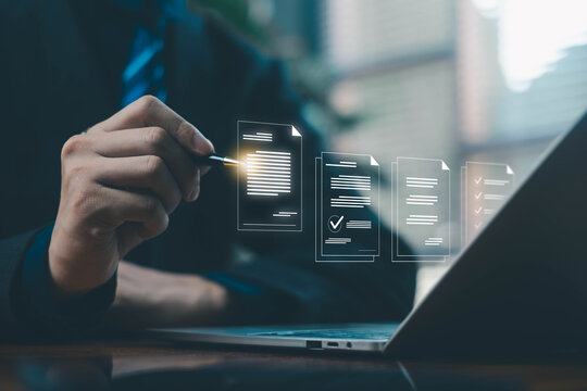 Businessman review digital documents on a laptop, representing online document management, verification workflow, file processing, and organized digital paperwork. document file electronic
