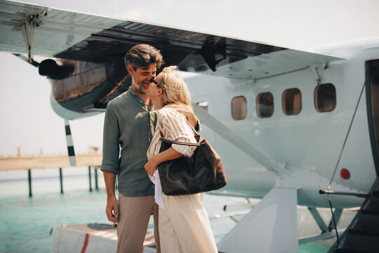 Couple enjoying their island arrival by seaplane during a tropical getaway