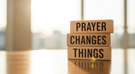 Inspirational Words of Faith: Prayer Changes Things a symbol of hope and faith, presented on wooden blocks placed on a table.