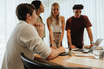 Young professionals collaborating in a modern workspace during a creative brainstorming session