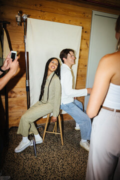 Gen z coworkers in a creative photo session with modern styling and candid smiles