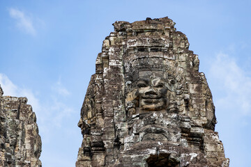 Close-up of carved face on Bayon Temple tower. Mysterious, historical mood. Ideal for heritage,...