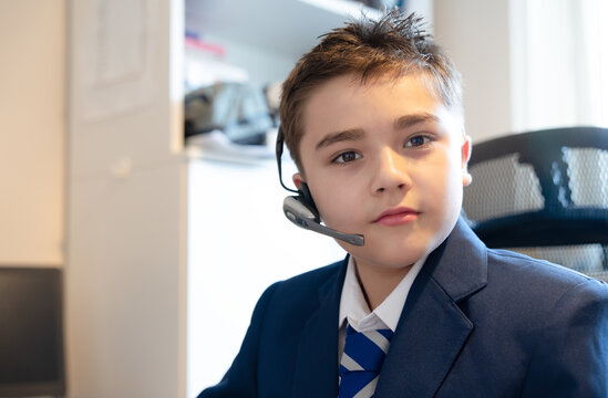 Portrait teenage boy in blue school uniform with striped tie,wearing headset microphone for digital communication,online education.Back to school,Hybrid learning lifestyle,Student