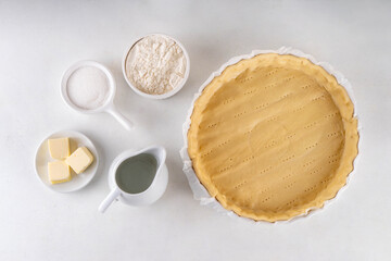 Ingredients for cooking baking traditional american Water Pie - pie shell, water, flour, butter and sugar. Great Depression era recipe, sweet buttery pie cake with translucent custard custard