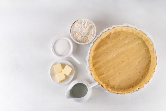 Ingredients for cooking baking traditional american Water Pie - pie shell, water, flour, butter and sugar. Great Depression era recipe, sweet buttery pie cake with translucent custard custard