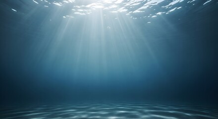 Deep underwater view with sunlight rays piercing the blue ocean surface, creating a serene and abstract background for aquatic themes