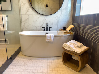 Freestanding tub in modern bathroom setting