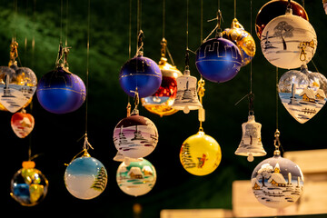 Christmas decoration with ornaments lights fir branches golden baubles red ribbons and festive details creating holiday atmosphere indoor seasonal design bright colorful winter celebration style scene