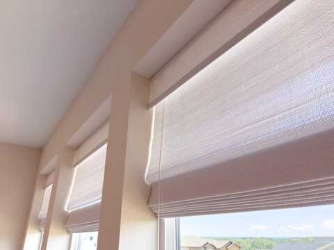 Sunlit Room With Roman Shades And Triple Window