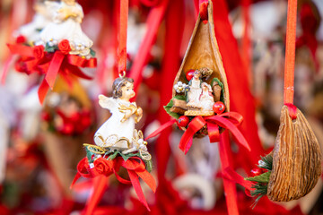 Christmas decoration with ornaments lights fir branches golden baubles red ribbons and festive details creating holiday atmosphere indoor seasonal design bright colorful winter celebration style scene