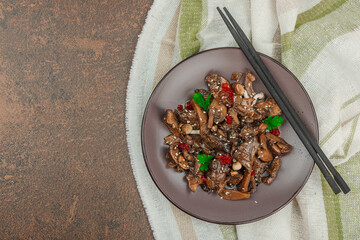 Delicious Shimeji mushrooms with chili pepper, sesame seeds and greens. Healthy Umami vegan food