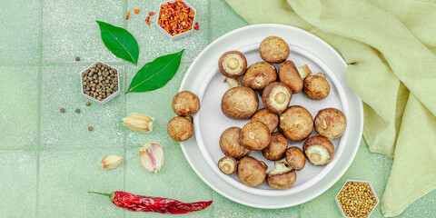 Fresh raw cremini mushrooms with spices and herbs. Healthy ingre