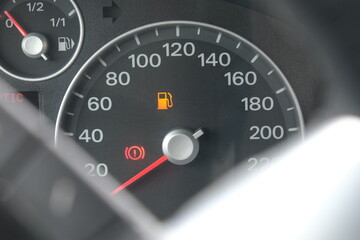 Yellow fuel icon on car dashboard speedometer, rising fuel costs and inflation concept, gasoline, auto.