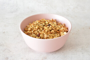 Healthy Granola in a Pink Bowl isolated on gray