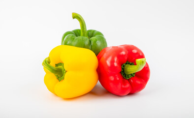 Green , yellow and red bell pepper on a white background.