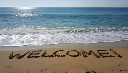 The word 'WELCOME!' written in the golden sand on a sunny beach with gentle ocean waves.