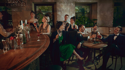 Joyful retro toast with elegant friends celebrating in stylish vintage bar. Concept of nightlife promos, New Year campaigns, premium bar advertising, and social lifestyle content.