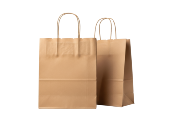 Two natural brown kraft paper shopping bags with twisted handles, one central, one angled, showcasing distinct texture on a transparent studio background, concept of eco-friendly packaging