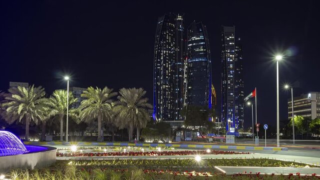 night time illuminated abu dhabi city downtown traffic fountain street circle panorama timelapse 4k united arab emirates  