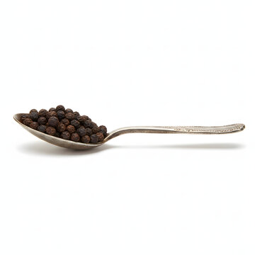 Old Metal Tablespoon Filled with Black Peppercorns Isolated on White