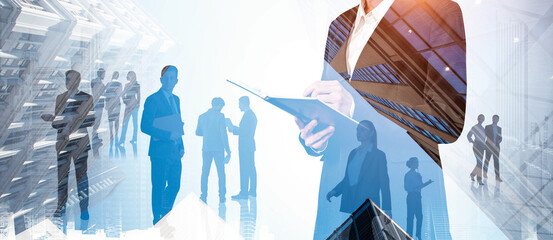Silhouettes of business people overlaid with modern city buildings in abstract double exposure...