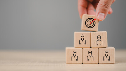 Strategic customer targeting concept with wooden blocks forming a pyramid, highlighting client retention, business focus, and audience segmentation. Perfect for market strategy and CRM visuals.