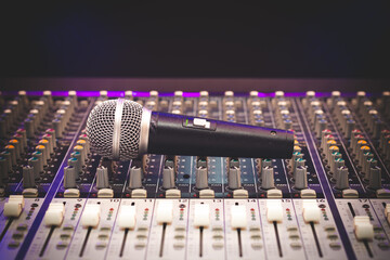 dynamic microphone on audio mixing console. singing, recording concept