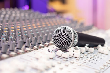 dynamic microphone on audio mixing console. singing, recording concept
