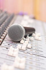dynamic microphone on audio mixing console. singing, recording concept