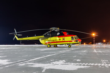 Medical helicopter on winter airport at night