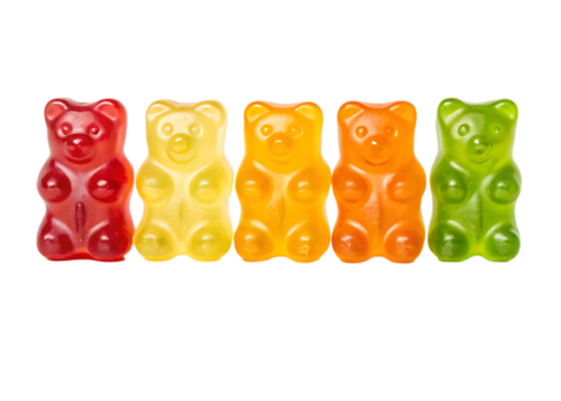 Close up of five gummy bears in a row with red yellow orange and green colors on a black background