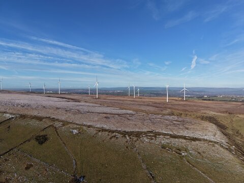 Aerial view of wind turbines on the top of a deserted mountain. Taken in Bury Lancashire England. 