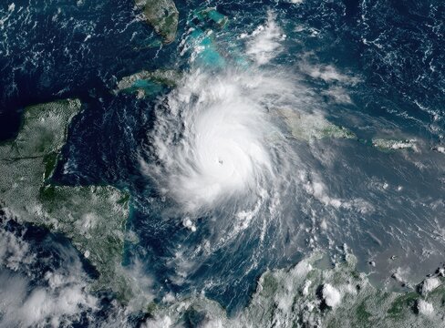 Massive hurricane swirling over turquoise ocean near islands viewed from space - Powered by Adobe